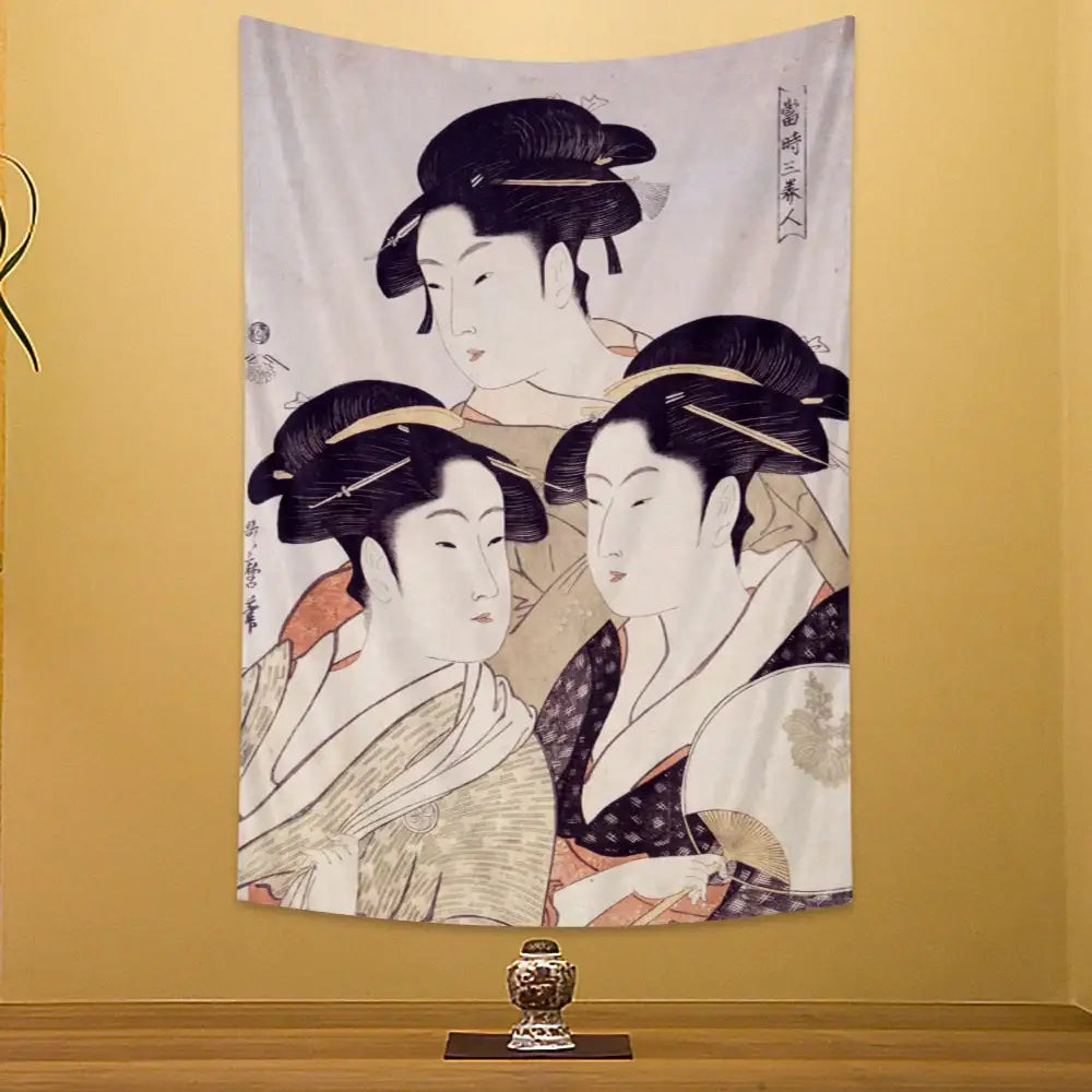 A soft beige fabric wall hanging featuring a geisha kanagawa print with three traditional japanese geishas in delicate ink