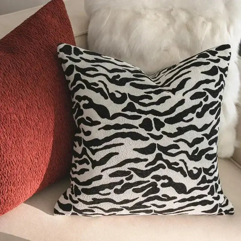Black and white zebra-print throw pillow with plush fabric finish complementing decorbites geometric jacquard cushion cover
