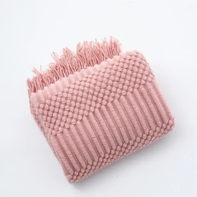 A soft pink knitted tassel blanket with textured dots and ridges by decorbites 3d knitted for bedroom decor