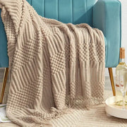 Beige decorbites 3d knitted tassel blanket featuring geometric patterns and fringe for bedroom throw decor