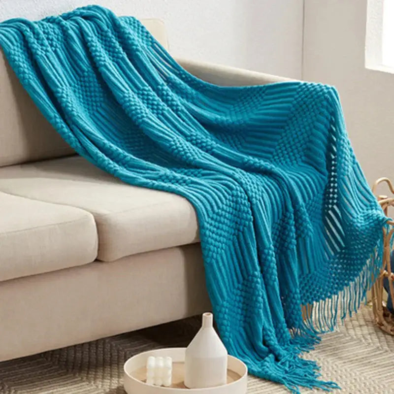 Vibrant turquoise decorbites 3d knitted tassel blanket with a ribbed pattern and fringe detailing for bedroom decor