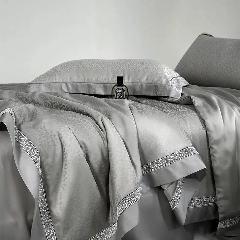 Silver-gray satin bedding set with subtle leopard jacquard summer print and intricate white lace trim by decorbites