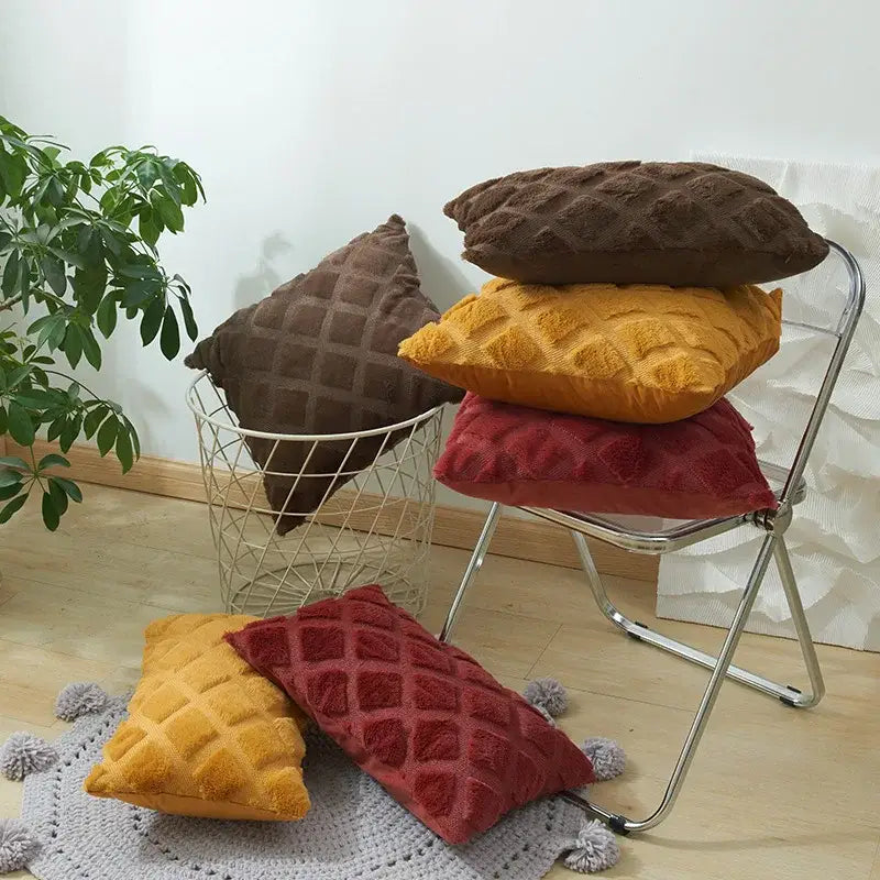 Stacked cushion covers in brown mustard and red with geometric diamond pattern in plush corduroy fabric for living room