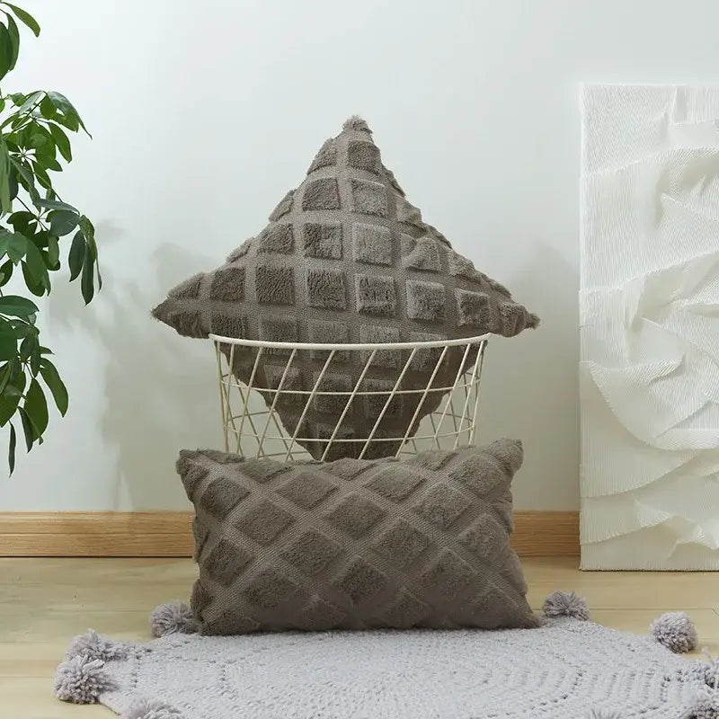Beige and gray cushion cover with geometric diamond pattern and textured pom-poms for living room decor