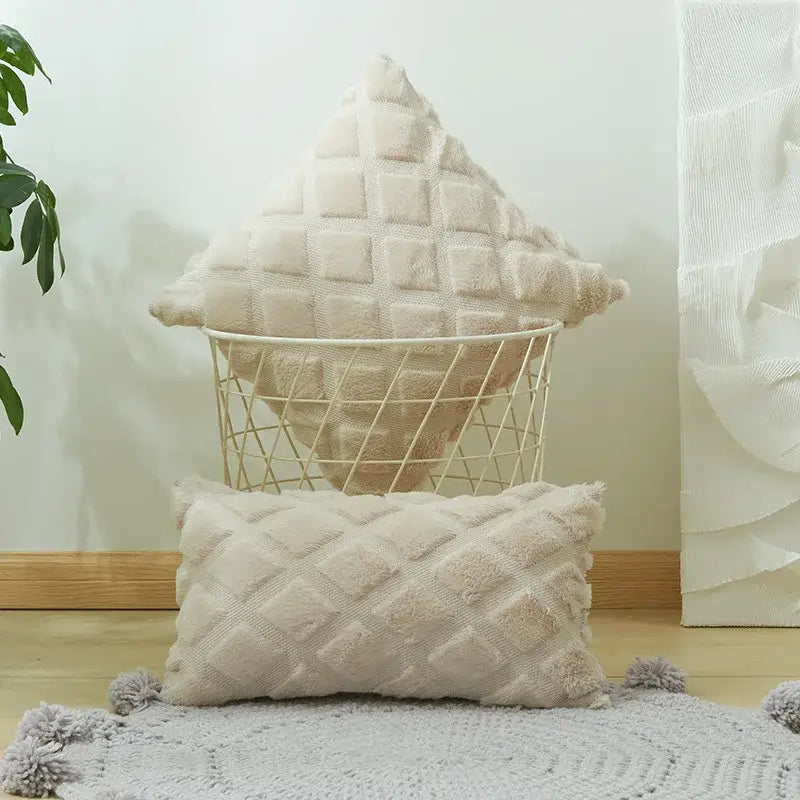 Cream-colored plush cushion cover with quilted geometric diamond pattern and soft fringe tassels for living room