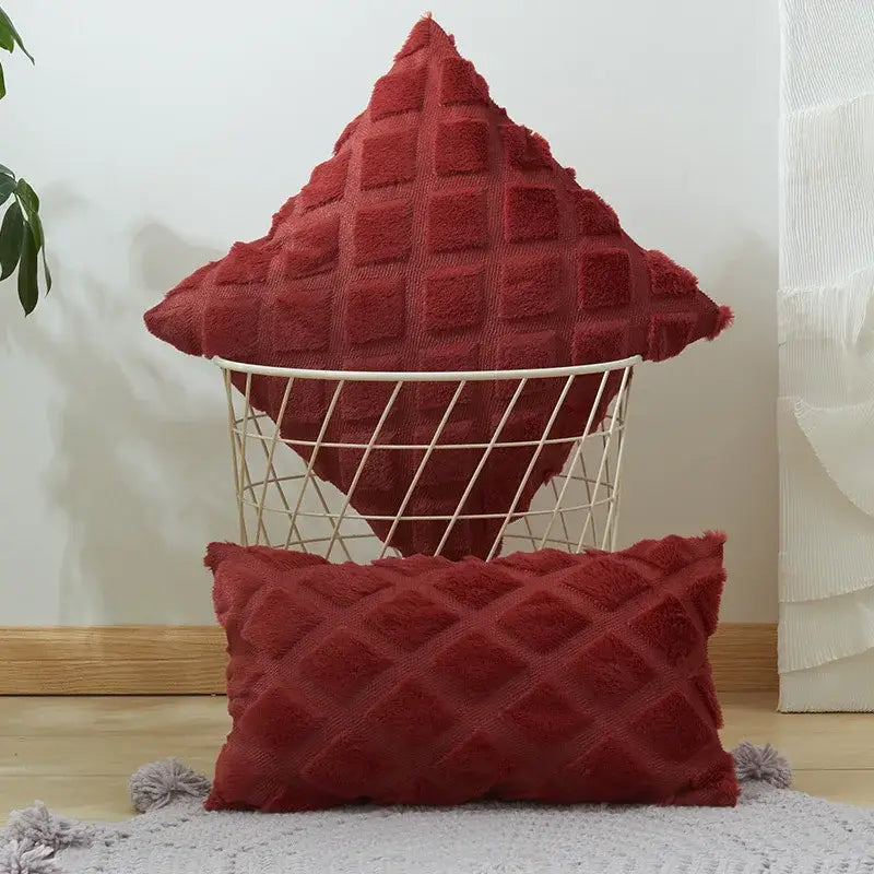 Red textured throw pillows with frayed edges featuring geometric diamond pattern complementing beige gray cushion cover
