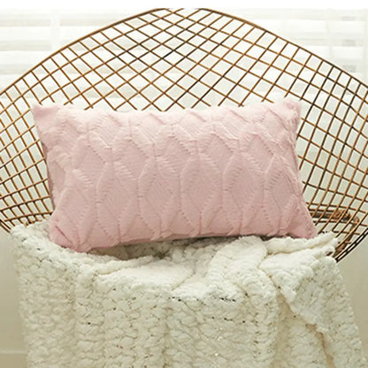 A soft pink cushion cover with a textured geometric diamond pattern ideal for living room decor