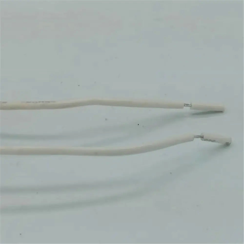 Two white insulated wires with metal connectors attached to beige gu10 ceramic socket holder with metal bracket