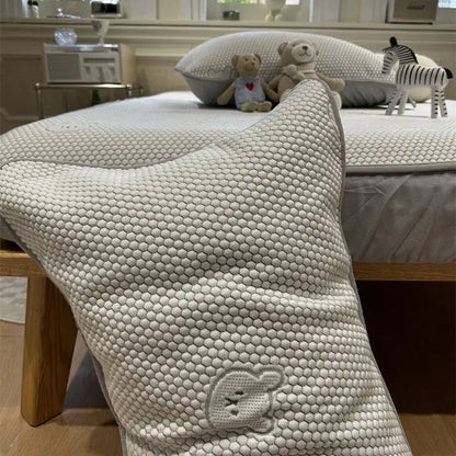 A soft off-white honeycomb pillow with embroidered bunny face in beige honeycomb bear decorbites cooling ice bean sheet set