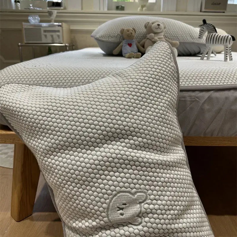 A soft off-white honeycomb pillow with embroidered bunny face in beige honeycomb bear decorbites cooling ice bean sheet set