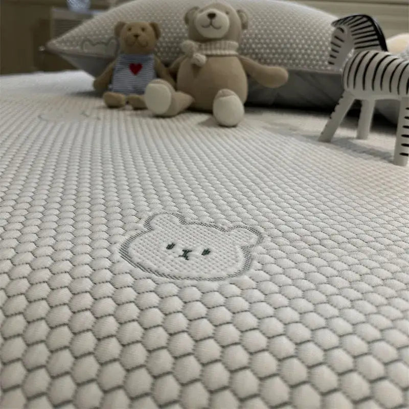 Beige honeycomb bear decorbites cooling ice bean sheet set featuring a white mattress with hexagonal texture and embroidered bear face