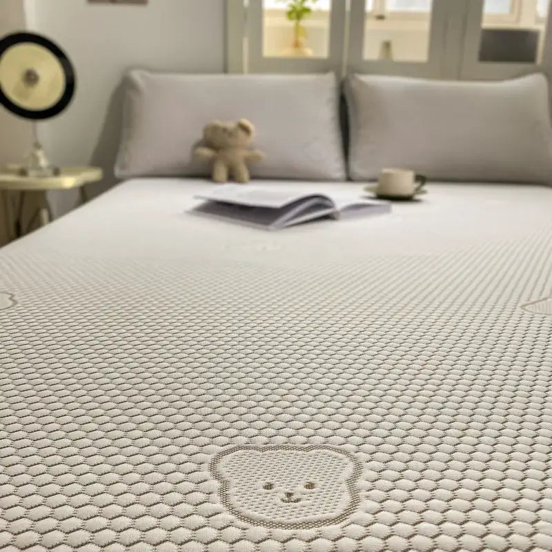 Beige honeycomb sheet set with a white textured cover featuring an embroidered bear face for decorbites cooling ice use