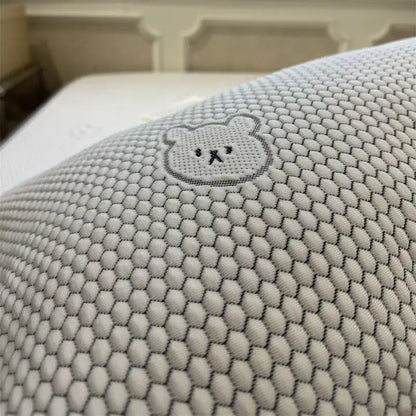 White pillow with hexagonal mesh texture and embroidered bear face in beige honeycomb bear decorbites cooling ice bean sheet set