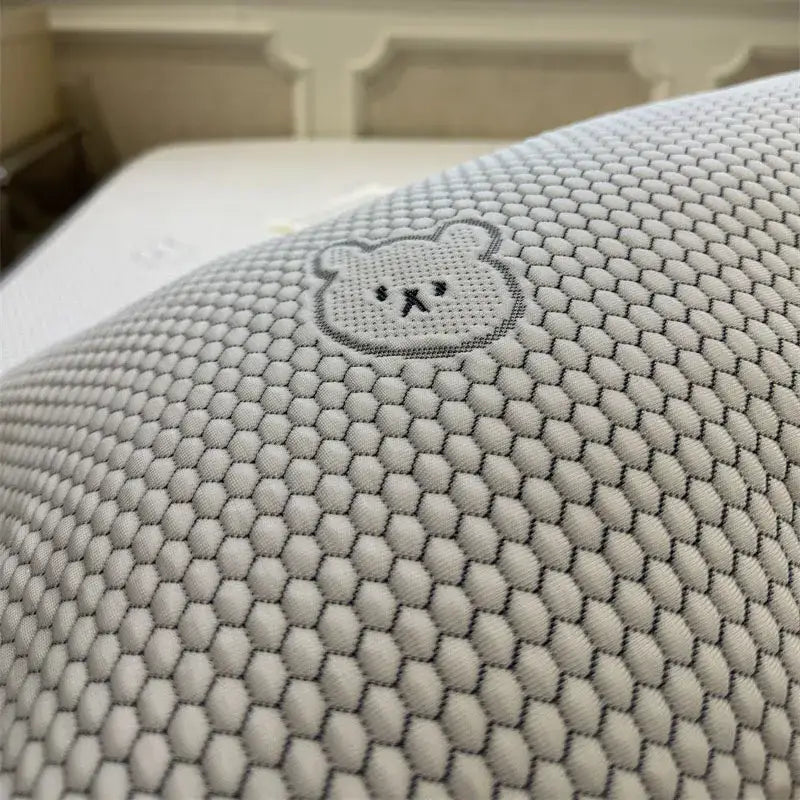 White pillow with hexagonal mesh texture and embroidered bear face in beige honeycomb bear decorbites cooling ice bean sheet set
