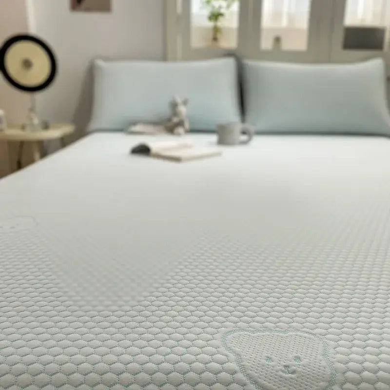 White textured mattress with honeycomb pattern and light blue embroidered bear face in beige honeycomb bear decorbites cooling ice bean sheet set