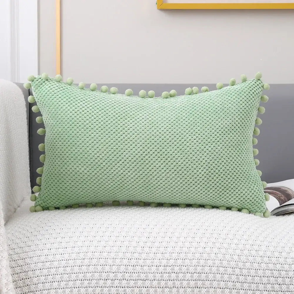 Light green knitted decorative pillow cover with pom-pom trim for living room decor and pillow cover use