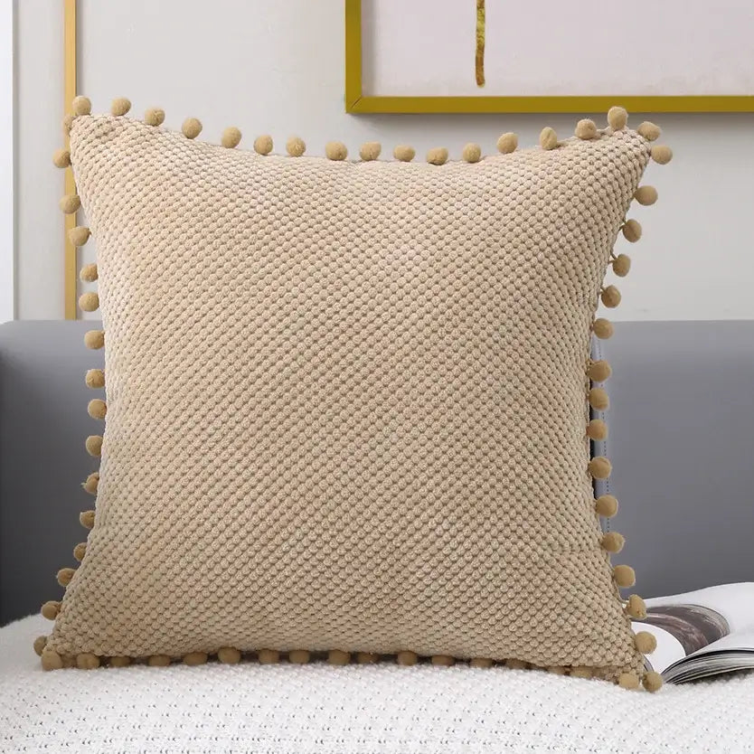Beige knitted decorative pillow cover with pom-pom trim for living room decor and stylish pillow cover use