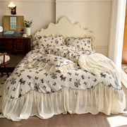 Cream-colored bedding set with beige lace ruffles and black floral butterfly print for elegant bedroom decorbites beige lace decor