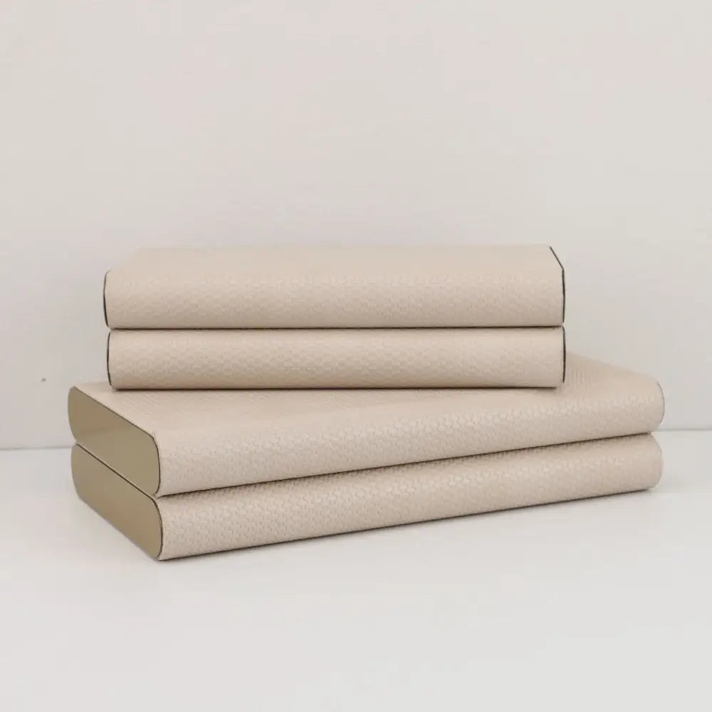 Stack of four beige leather jewelry box storage containers with textured covers and silver hinges for decorbites beige leather