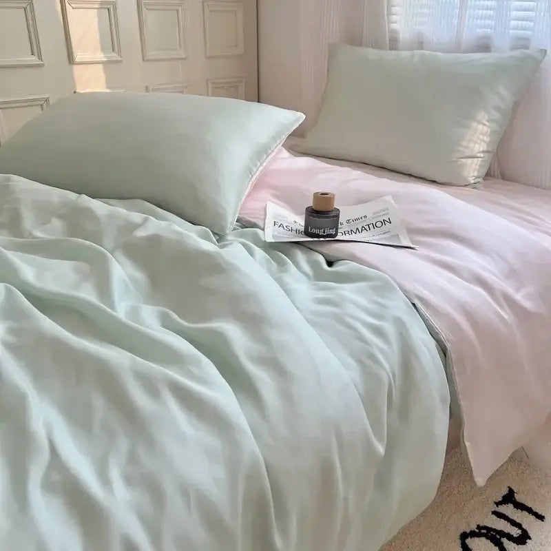 Soft mint green satin duvet cover with matching pillowcases and pale pink sheet from decorbites ice silky solid bedding set