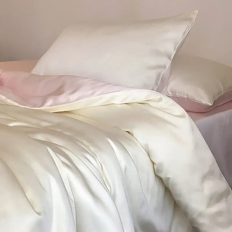 Beige and light blue ice silky solid bedding set featuring cream satin duvet cover with glossy finish and matching pillowcases