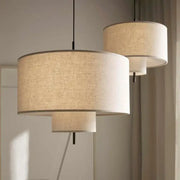 Beige linen handmade fabric chandelier with tiered drum pendant lights and black metal rods by decorbites handmade fabric