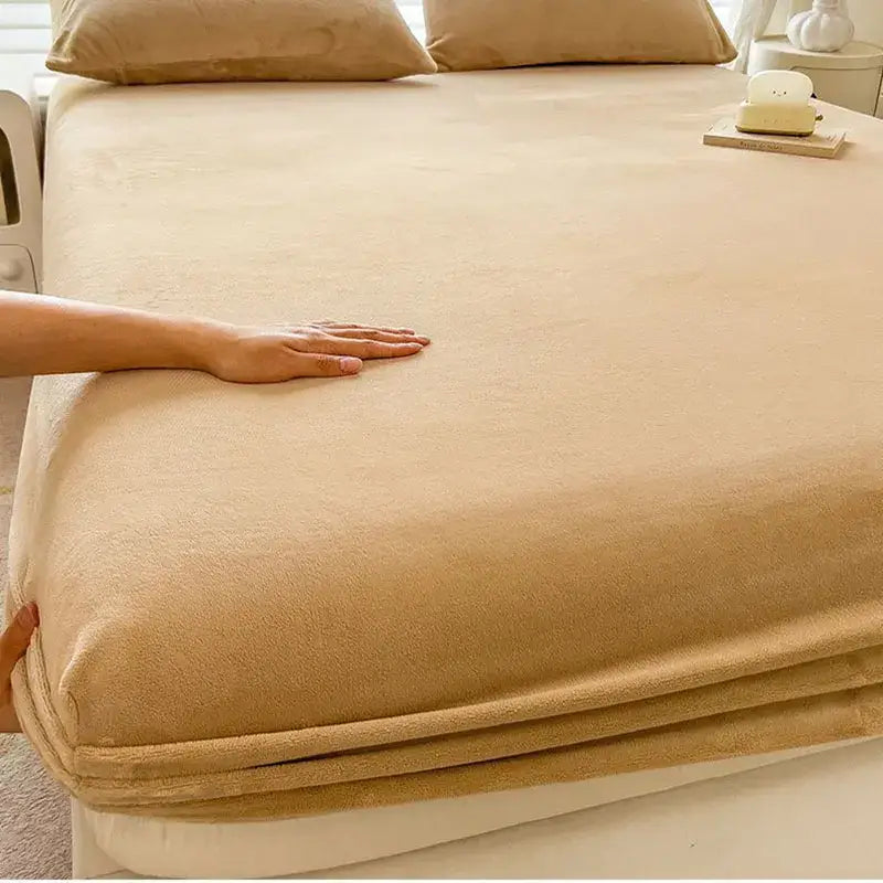 Beige milk velvet fitted sheet with soft velvety texture and neatly folded edges for plush mattress topper