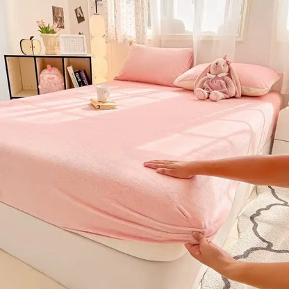 Pink plush fitted sheet with soft textured surface made of milk velvet fitted sheet for bedroom mattress topper