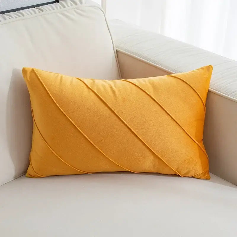 A plush mustard-yellow velvet pillow featuring hand pleat embroidered diagonal stitched pleats for living room use