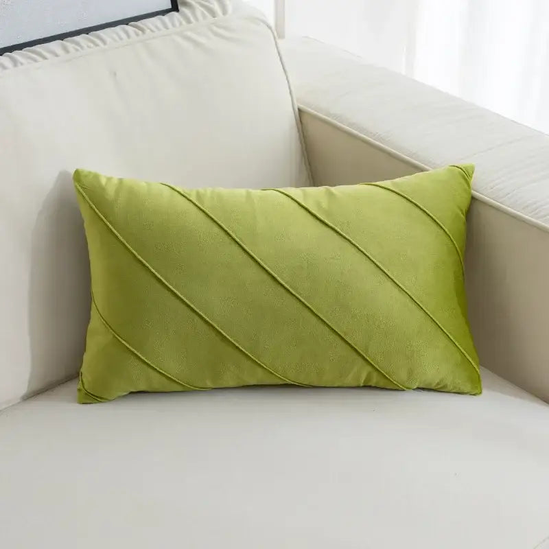 A rectangular lime green velvet pillow with diagonal hand pleat embroidered pleats for living room decor