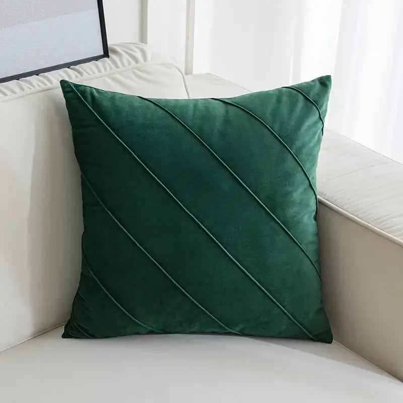 Deep emerald green velvet throw pillow with diagonal stitched detailing in hand pleat embroidered cushions design