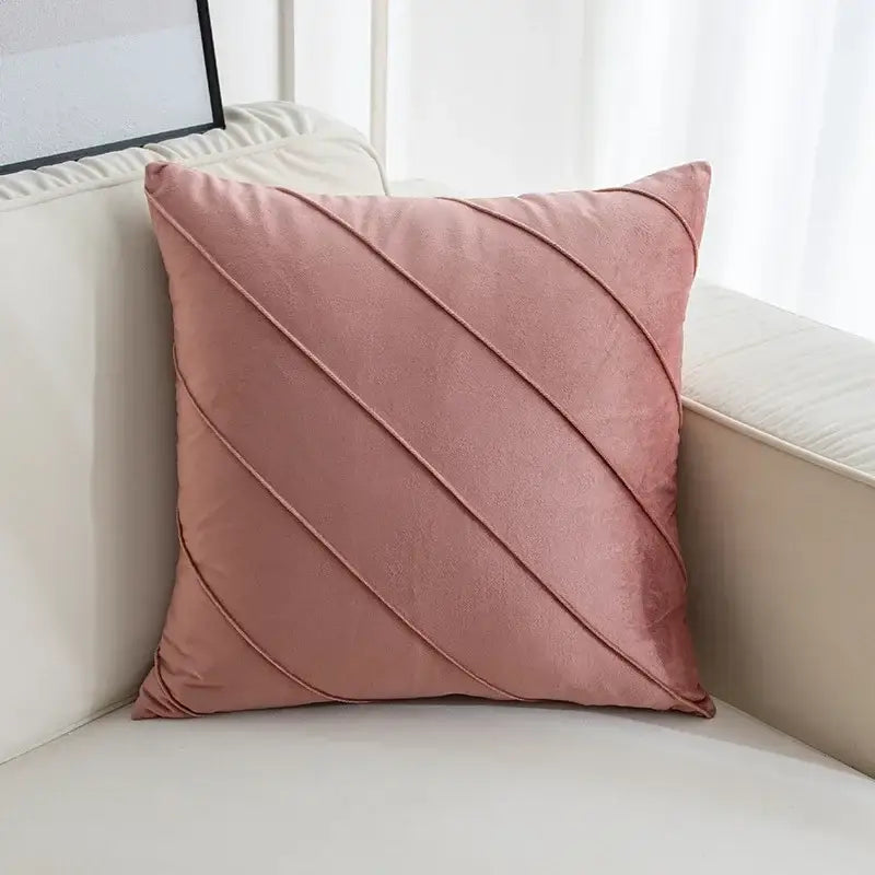 A soft pink velvet cushion with hand pleat embroidered diagonal pleats for living room decor