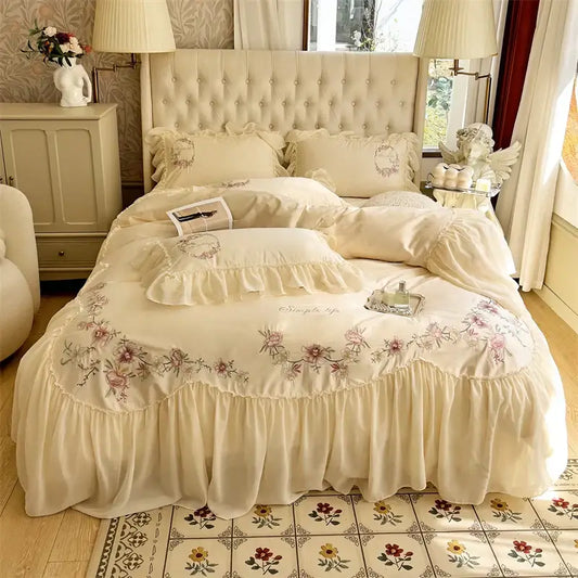 Cream-colored floral embroidered bedding set with ruffled edges and tufted headboard from decorbites beige pink lace collection
