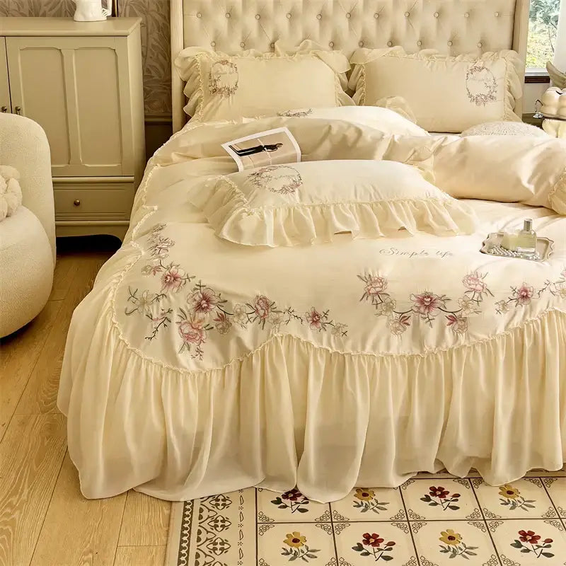 Cream-colored satin bed skirt with delicate floral embroidery and ruffled edges from decorbites beige pink lace bedding set