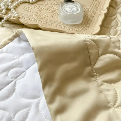 Beige satin quilted eucalyptus fiber bedspread with white floral stitching for elegant bedroom decorbites eucalyptus fiber cover