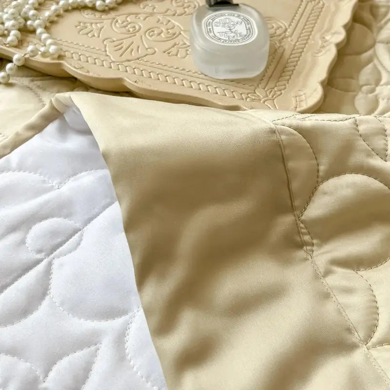 Beige satin quilted eucalyptus fiber bedspread with white floral stitching for elegant bedroom decorbites eucalyptus fiber cover