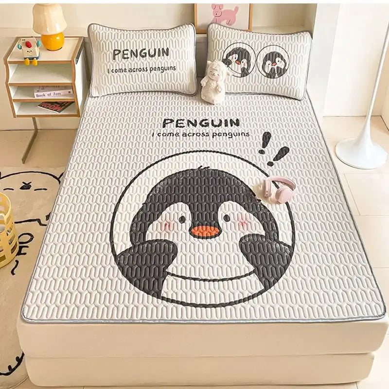 White quilted bed pad with large cartoon penguin and matching pillowcases in decorbites cartoon pattern latex mattress set
