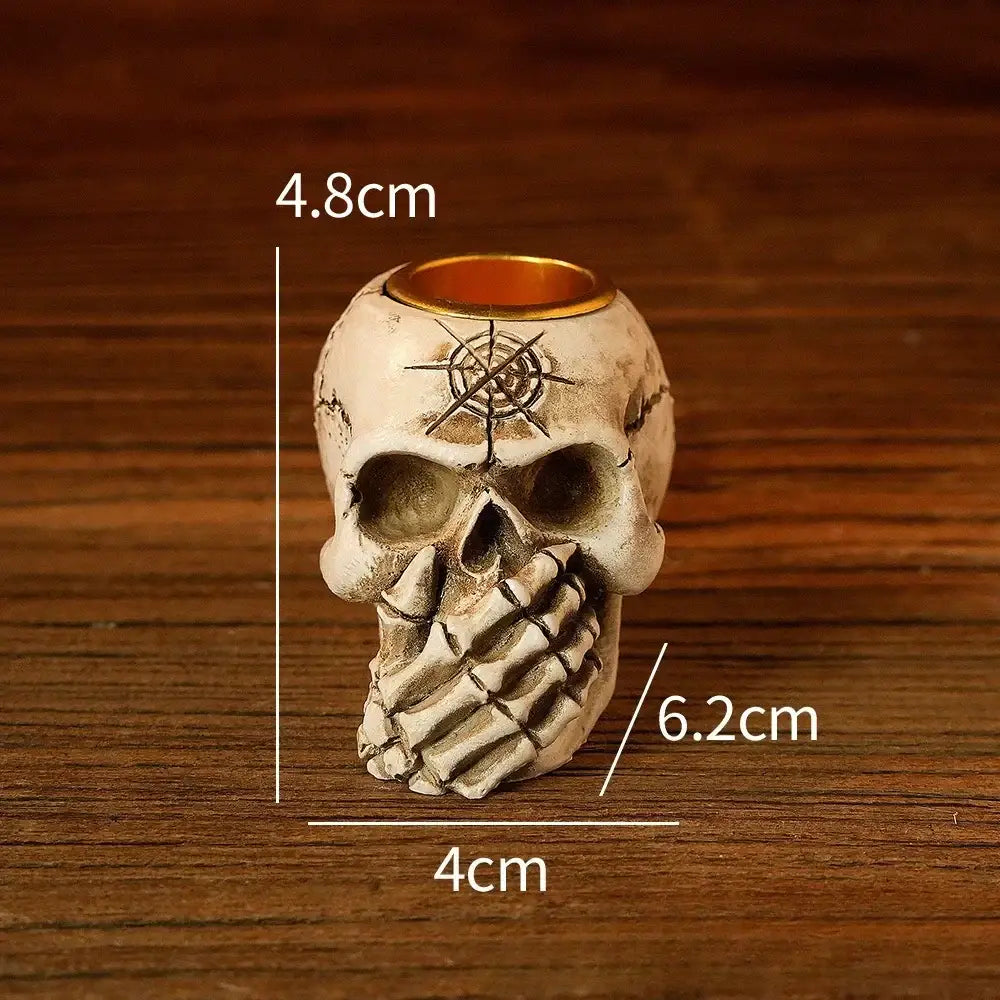 Beige resin bone skeleton candlestick holder with white textured skull design gold rim and engraved symbol decorbites bone skeleton