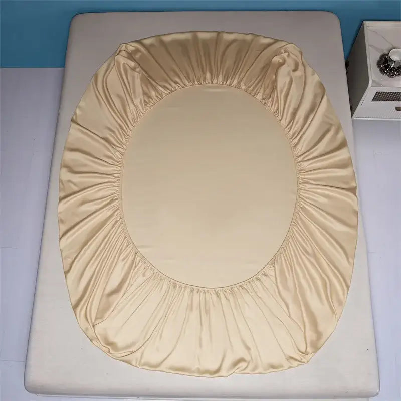 Beige satin toilet seat cover with elasticized edge complementing decorbites 1000tc egyptian cotton fitted sheet set