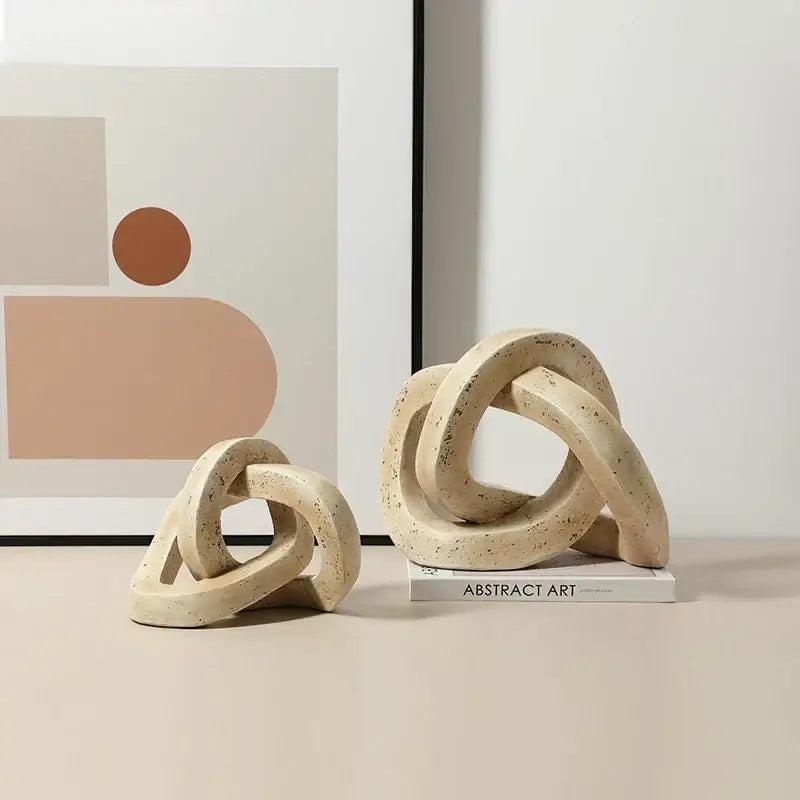 Beige speckled ceramic geometric interlocking loop knot sculpture for living room decor