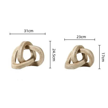 Beige ceramic living room sculpture with speckled finish and geometric interlocking loop knot design