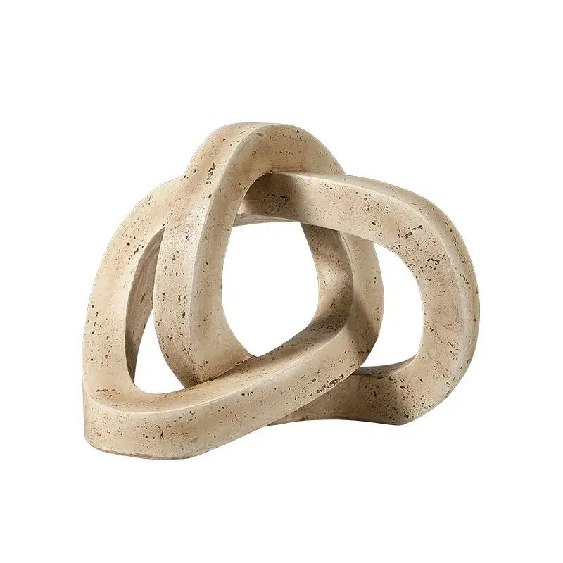 Beige speckled stone sculpture featuring a geometric interlocking loop knot design for living room decor