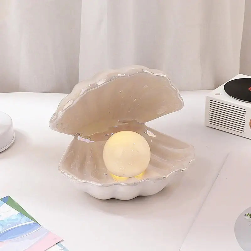 Beige translucent ceramic shell pearl night light with glowing yellow spherical light for bedroom decorbites ceramic shell decor