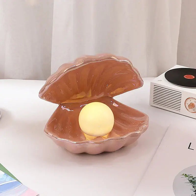 Beige and terracotta ceramic shell pearl night light with glossy finish and glowing yellow pearl for decorbites ceramic shell decor