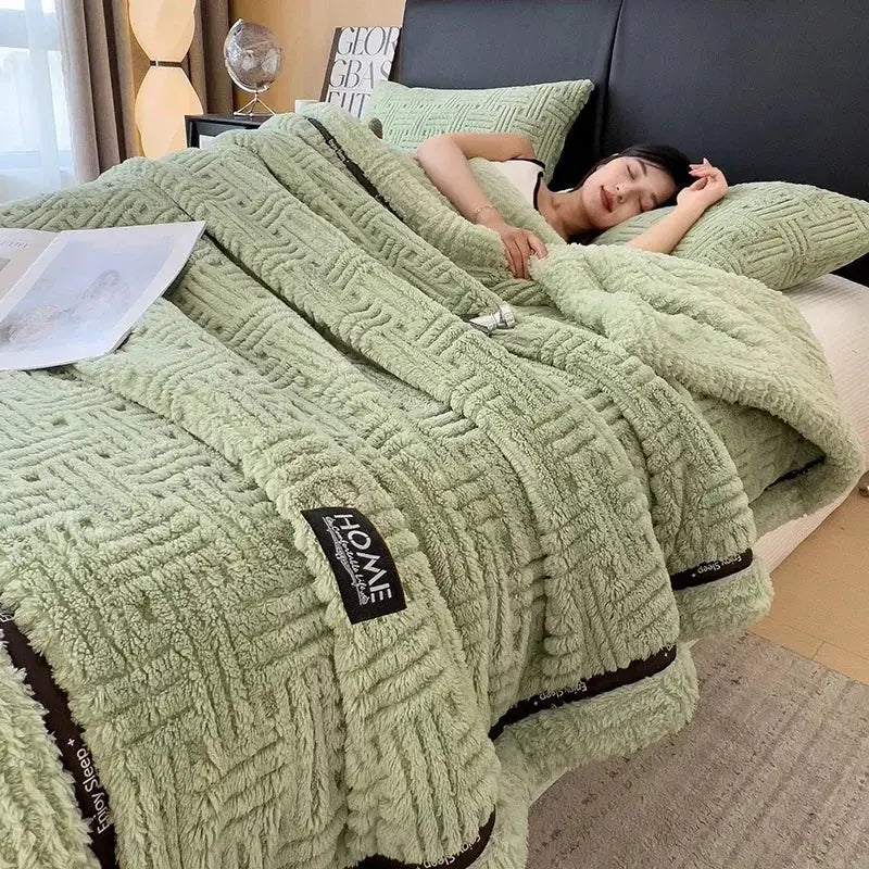 Soft mint green plush cozy fluffy fleece blanket with textured woven pattern and black trim by homme brand label