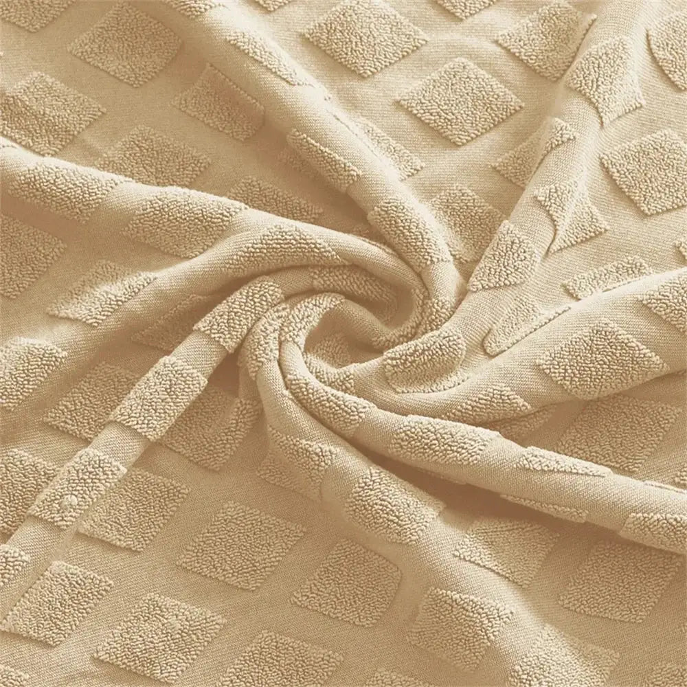 Beige textured jacquard elastic seat covers with raised diamond patterns for dining room chair decor by decorbites
