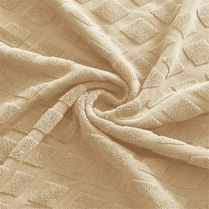 Beige textured jacquard elastic seat covers with raised diamond patterns for dining room chair decor by decorbites