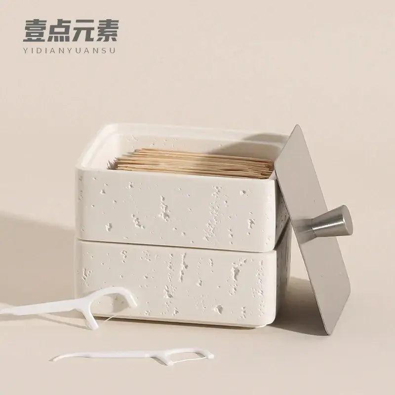 Beige textured natural stone double decker jewelry organizer with white speckled ceramic toothpick holder and silver lid