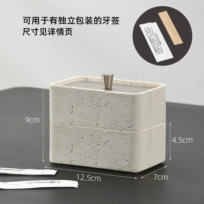 Beige textured natural stone double decker jewelry organizer with a modern off-white ceramic toothpick holder and metallic lid