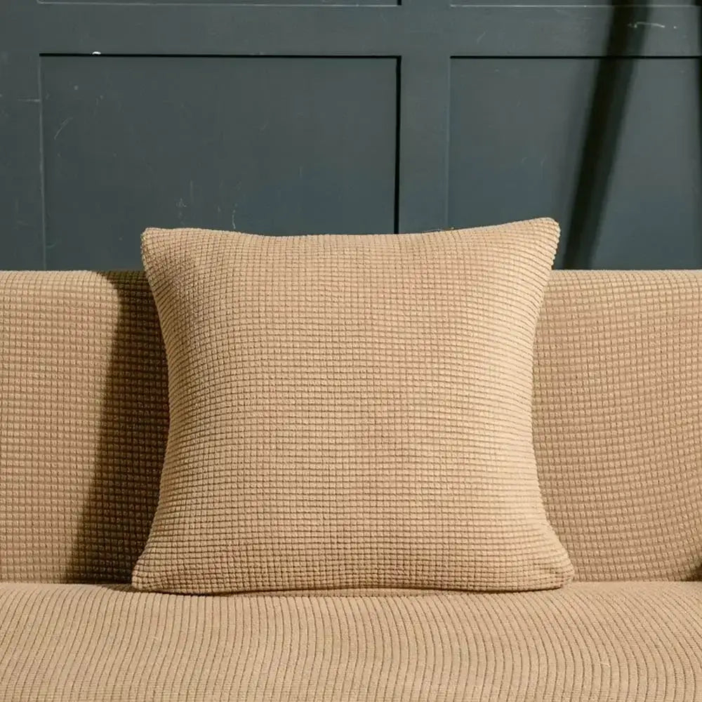 Beige waffle textured throw pillow resting on matching sofa with decorbites 3d quilted sofa cover for living room decor